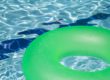 inflatable green float in swimming pool -- inflatables